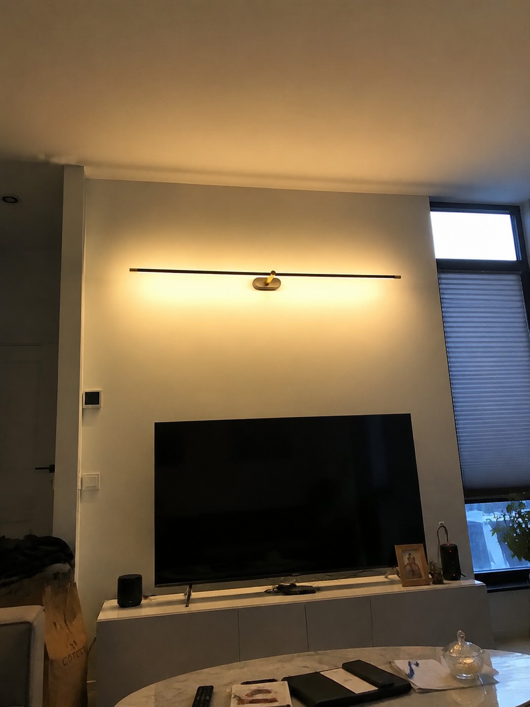 Kady wandlamp boven een televisie