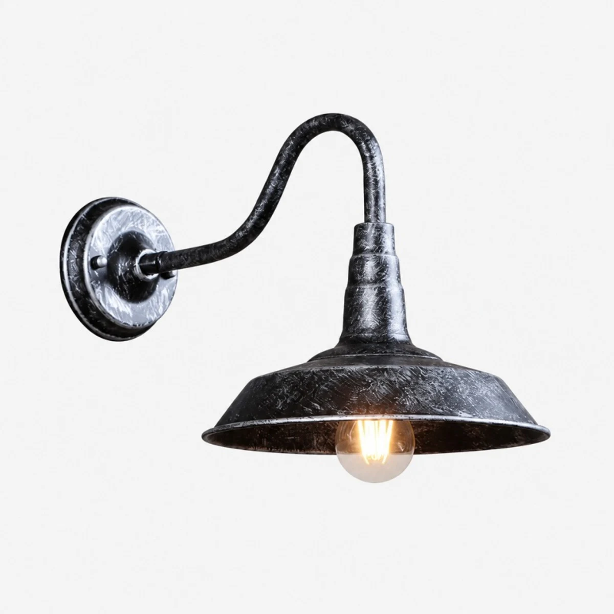Antique silver wall light with warm bulb lit