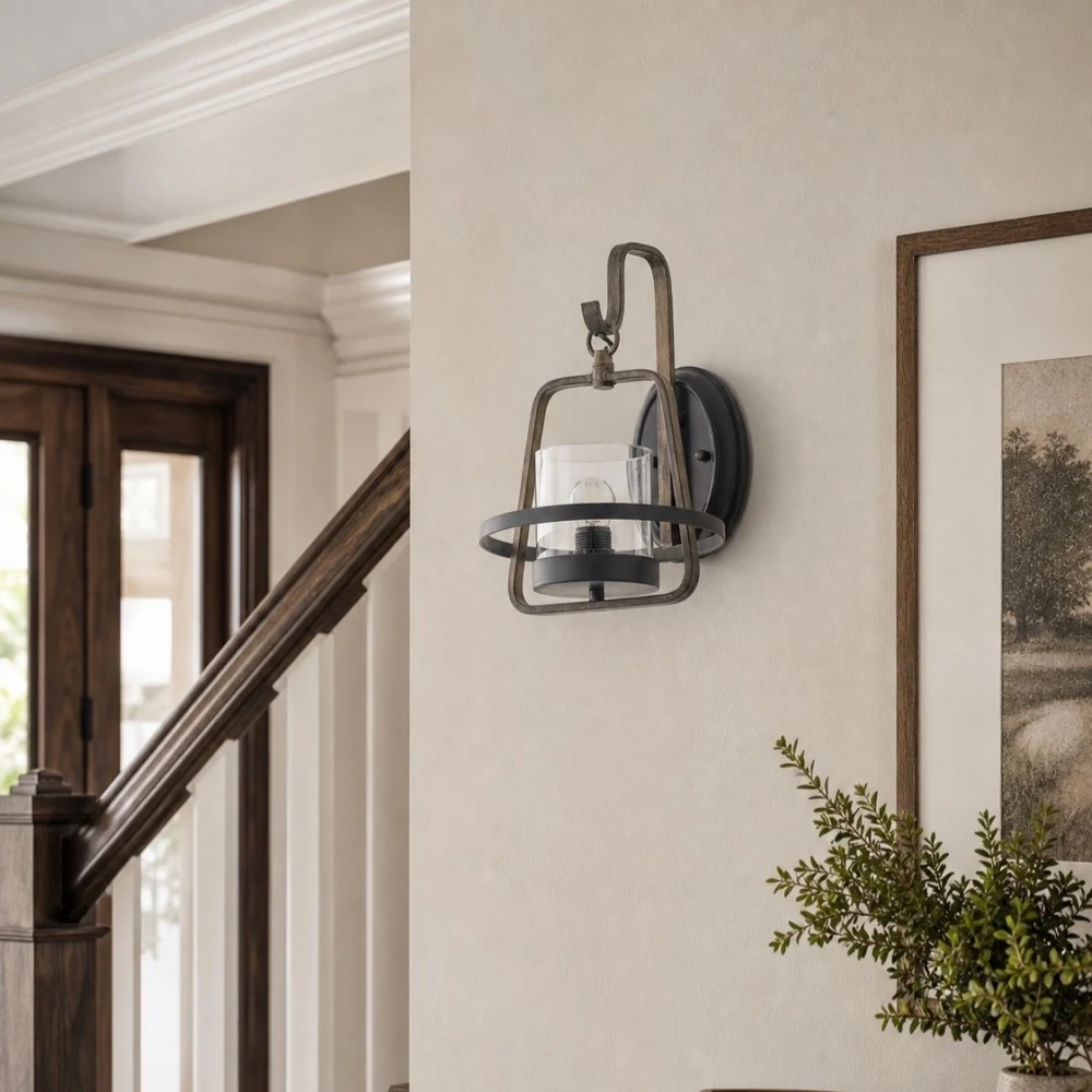 Rust metal clear glass wall sconce installed near staircase