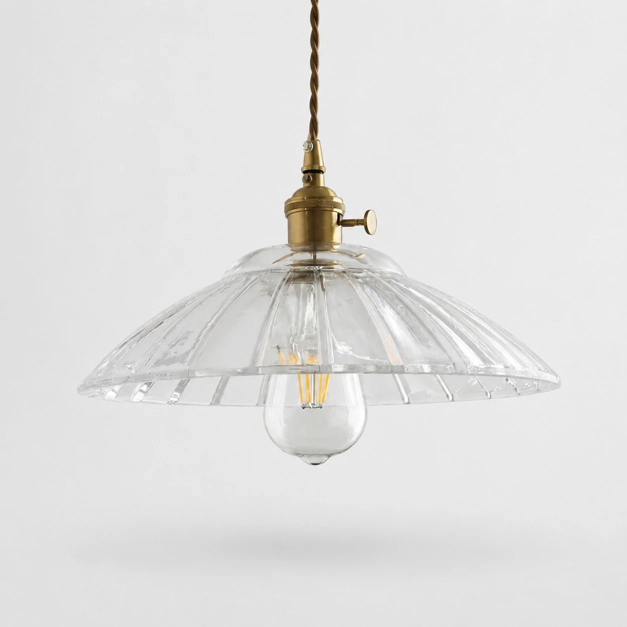Transparent glass pendant light on white background
