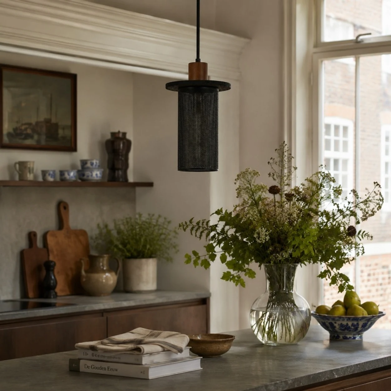 Black woven mesh pendant light in a warm kitchen shelf setting