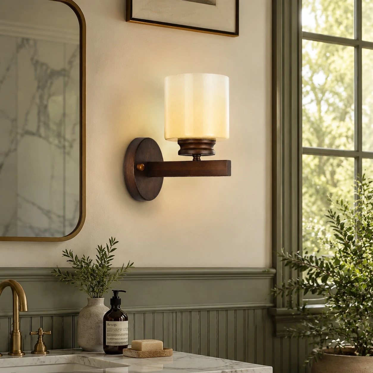Aged bronze wall sconce installed beside a bathroom mirror