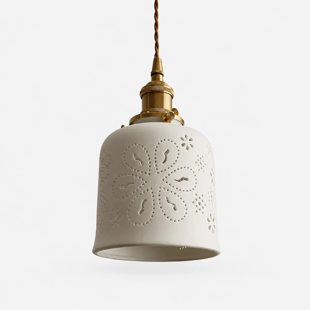 Floral cutout ceramic pendant light with brass hardware