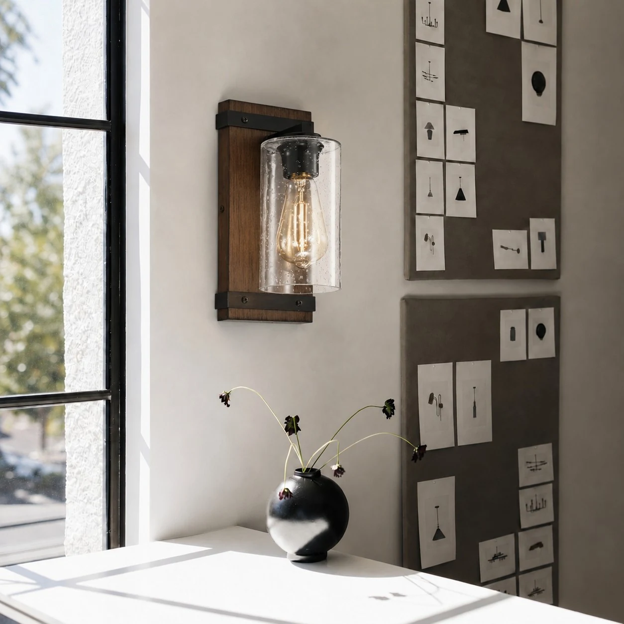 Wall sconce lighting a reading nook near a window