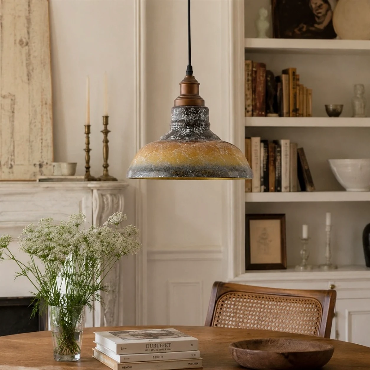 Smoky gray glass pendant light installed above a dining table