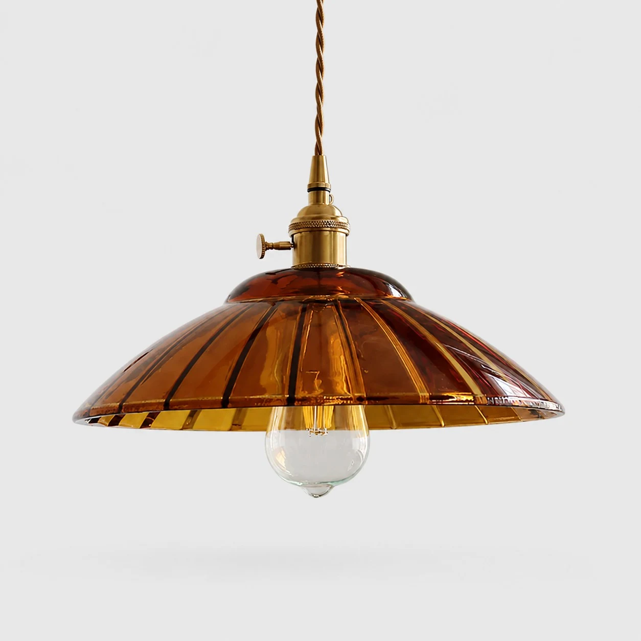 Amber glass pendant light on white background