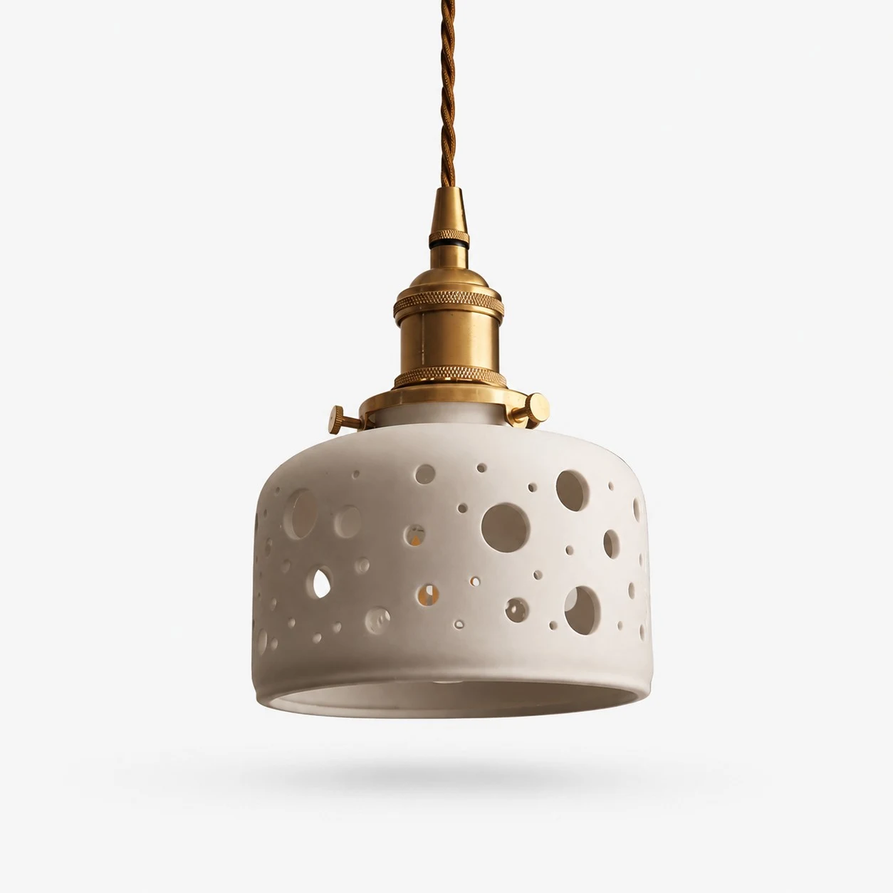 Round dot cutout ceramic pendant light with brass hardware