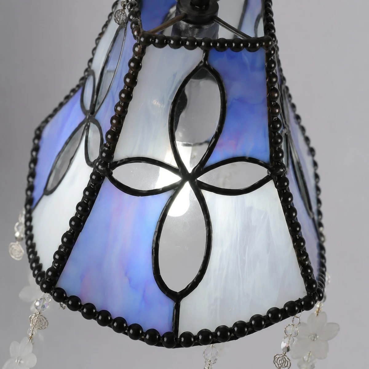 Side view showing shell shade panels and beaded frame
