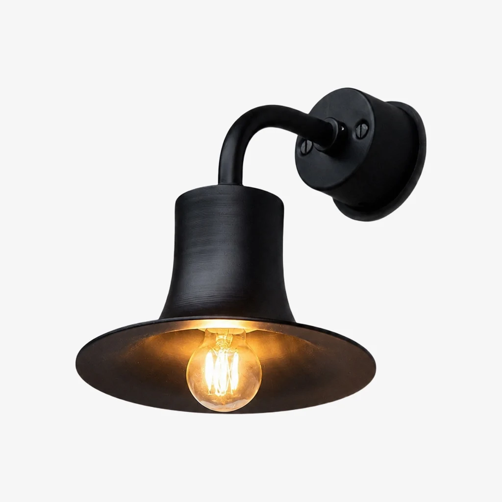 Matte black brass wall sconce with warm bulb glow