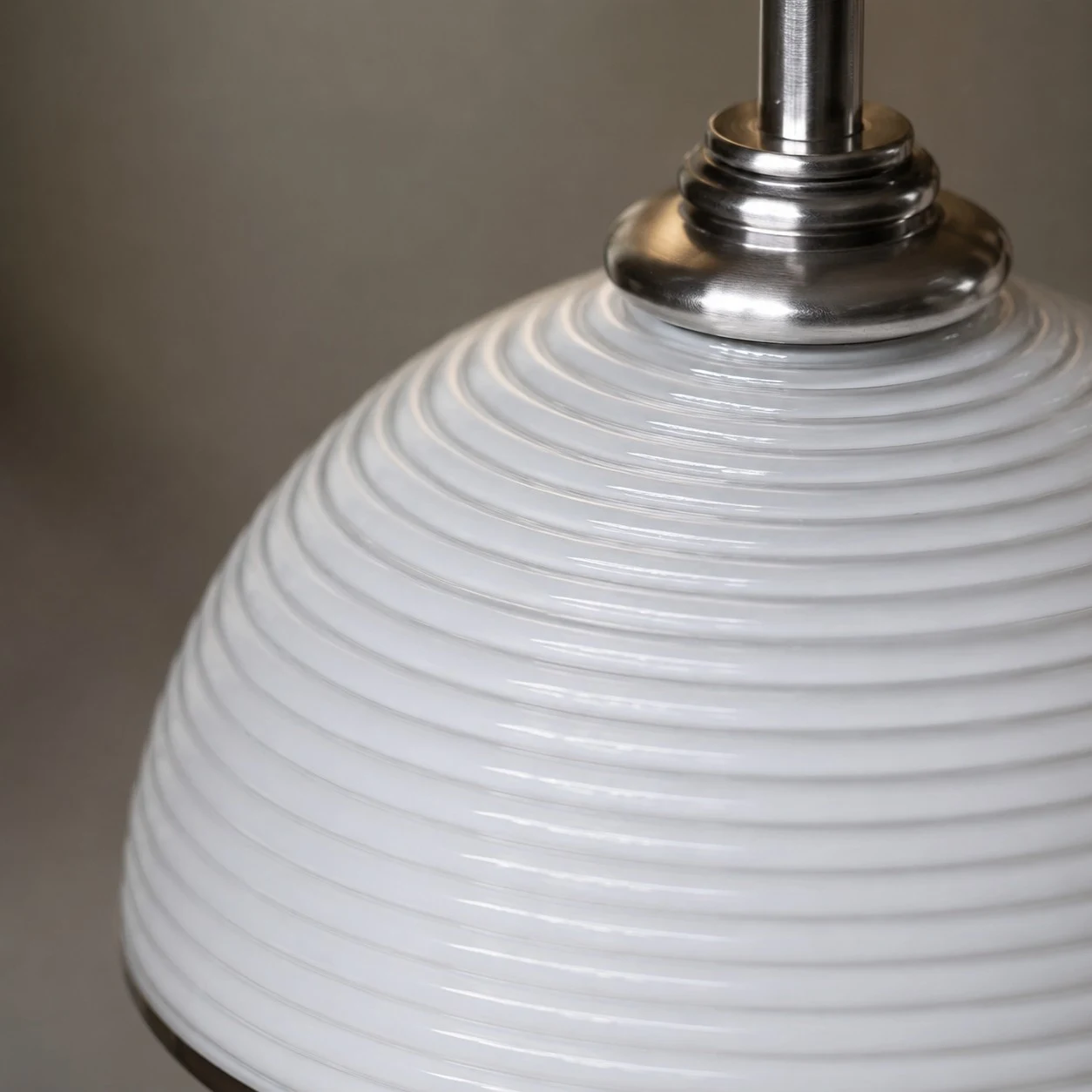 Close detail of the white ribbed shade and metal socket