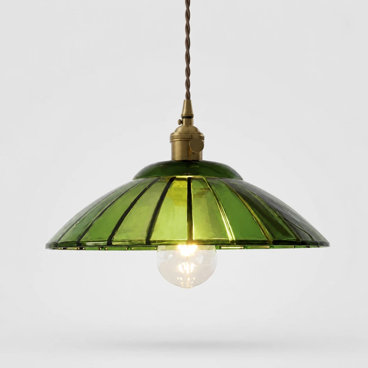 Green glass pendant light on white background