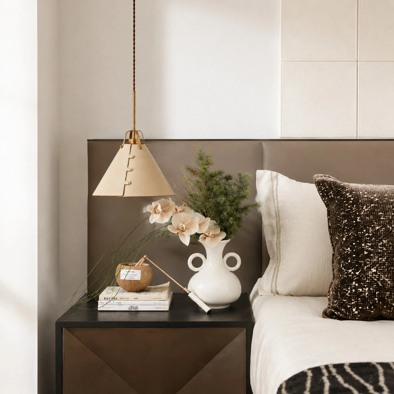 Leather pendant light beside a bedroom nightstand
