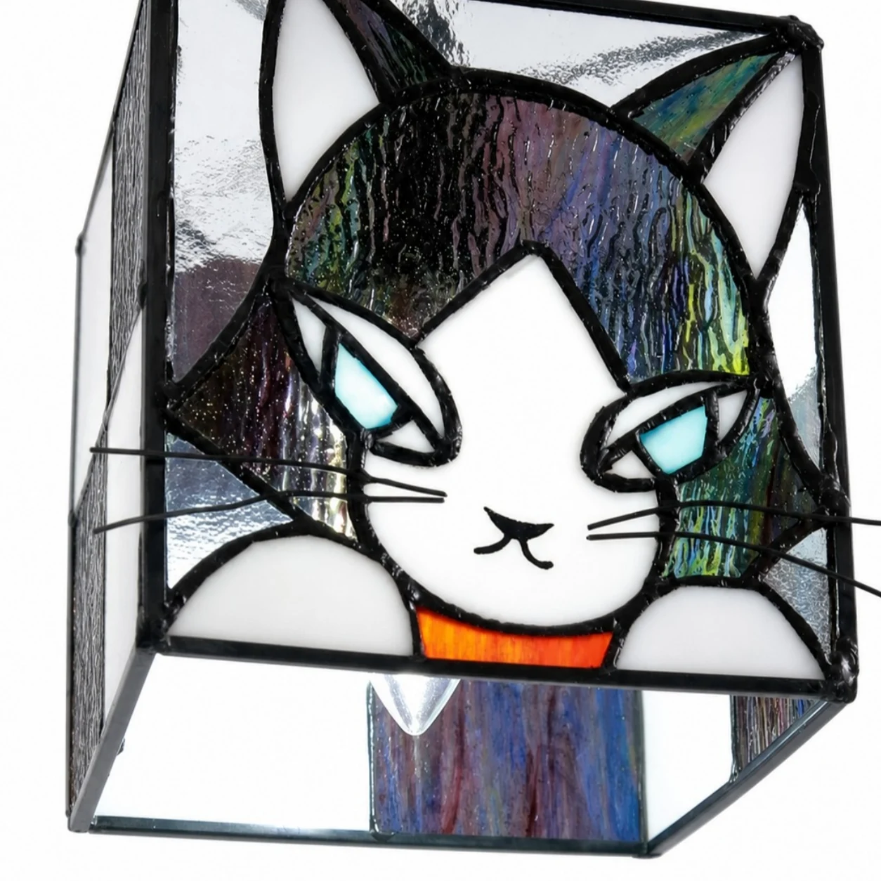 Close detail of cat face stained glass shade and soldered frame