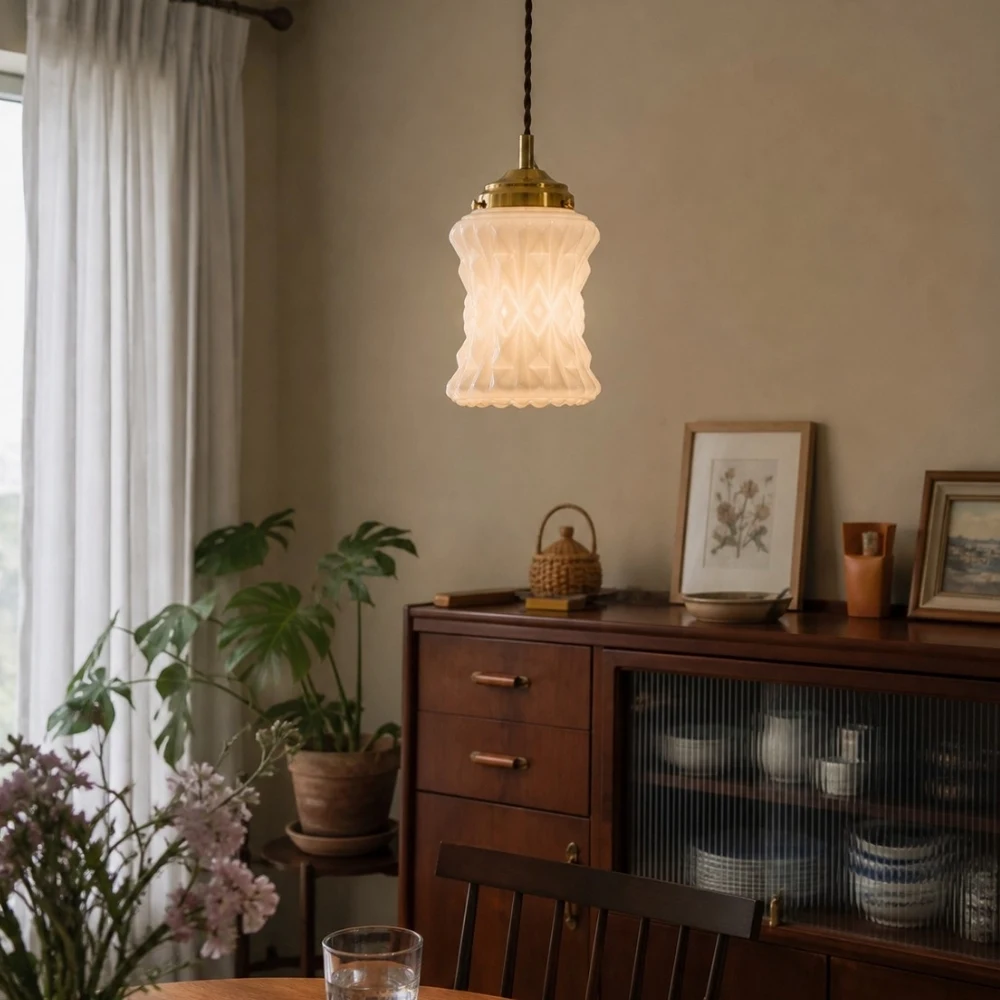 Warm glowing milk glass pendant in dining room