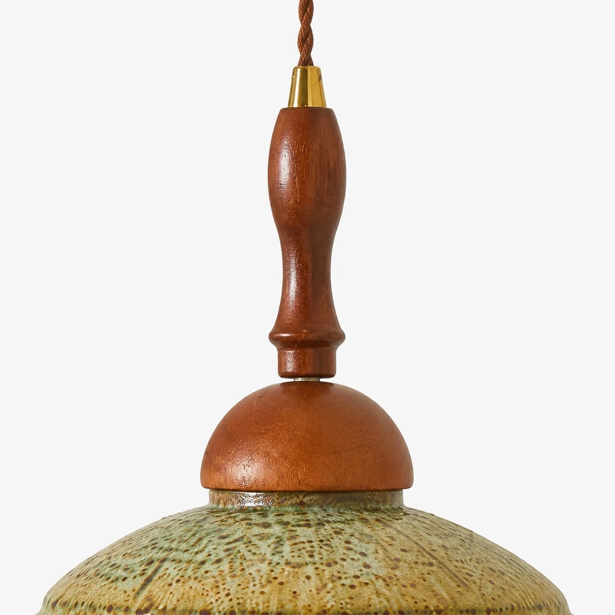 Close view of the warm wood stem, metal collar and textured shallow shade on the wall sconce