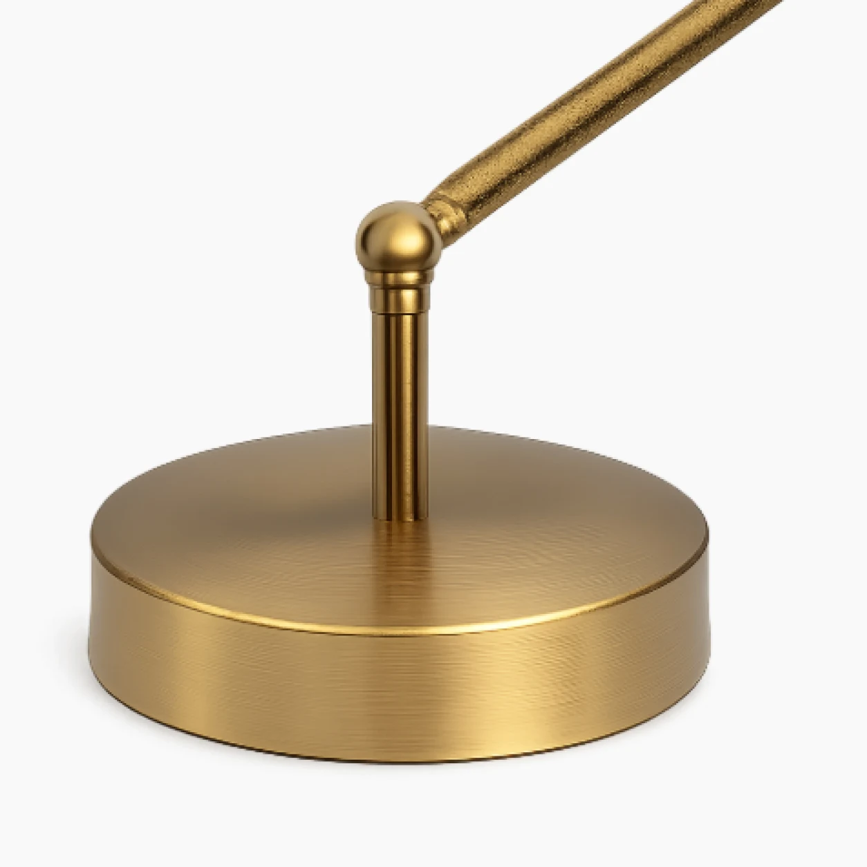 Close view of the brushed brass-tone round base and pivot joint