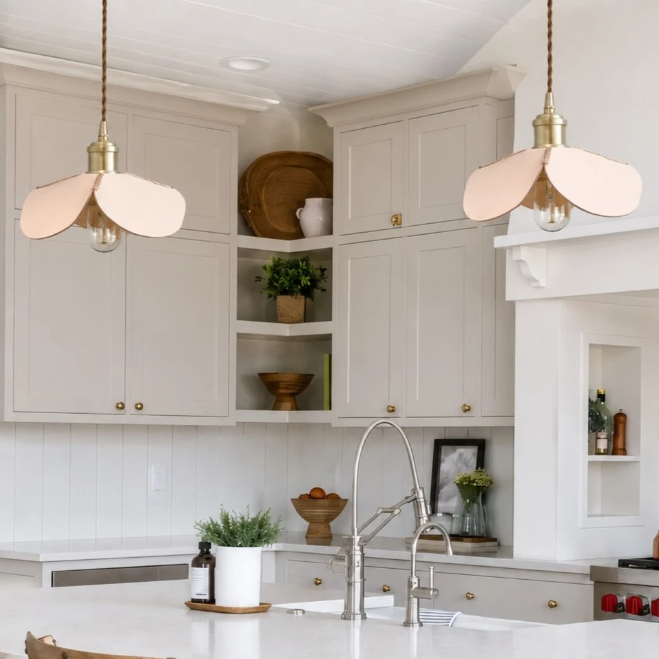 Leather petal pendant lights over a bright kitchen island
