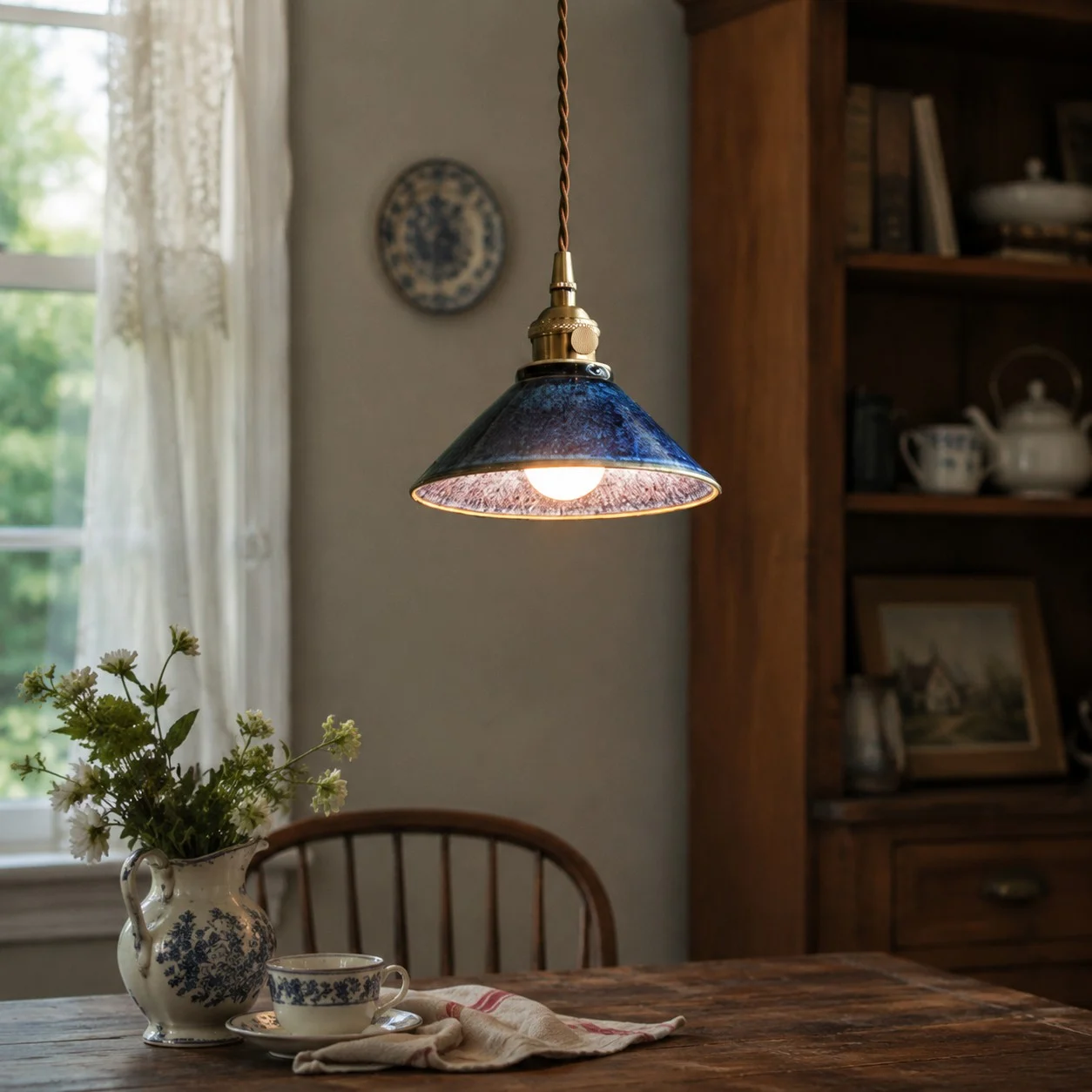 Blue glazed ceramic pendant light in a calm tea room setting