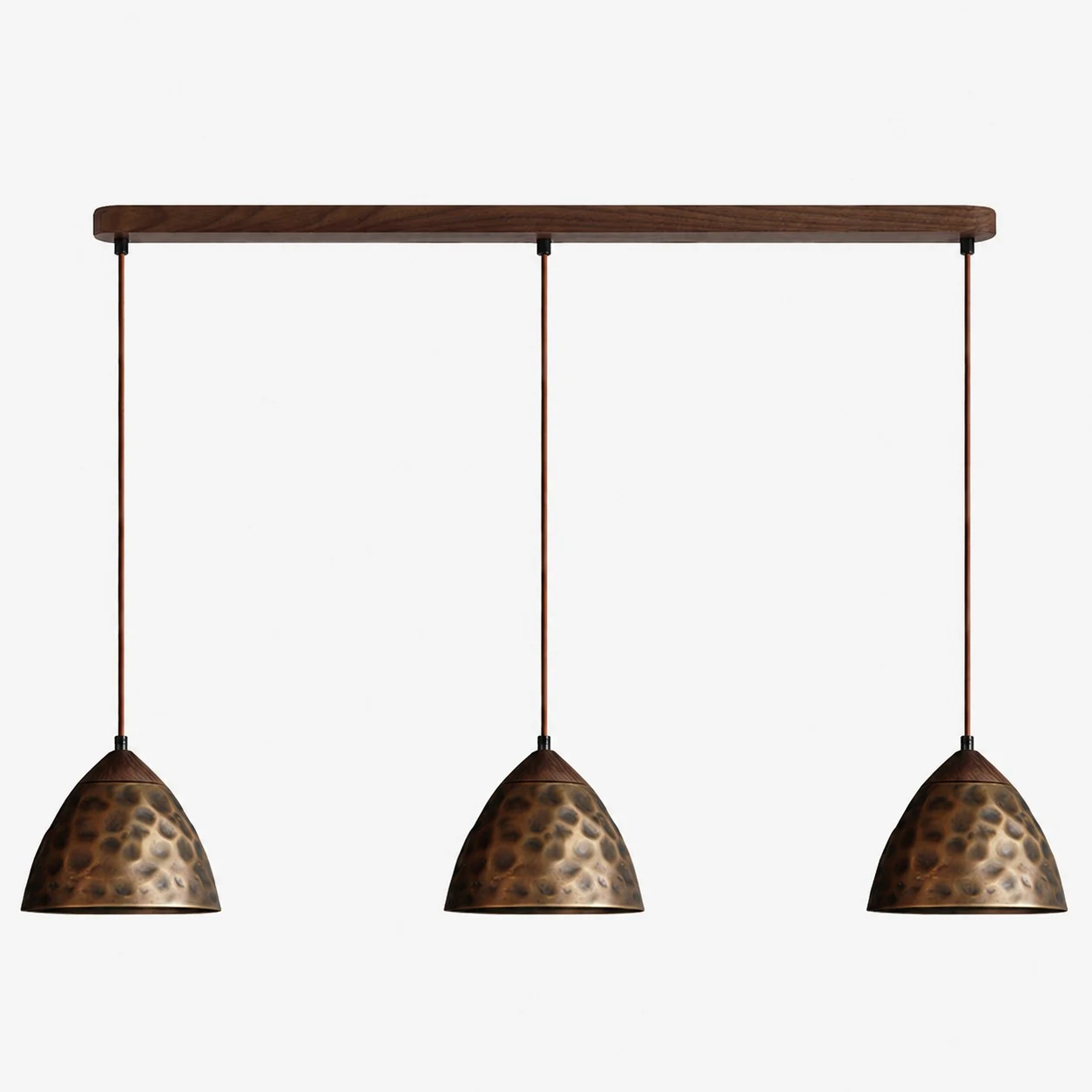 Three-light hammered copper hill pendant on walnut ceiling base