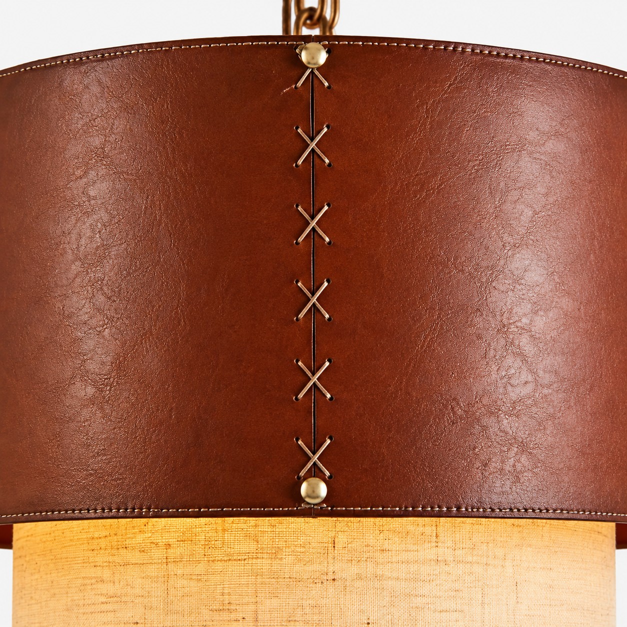 Lower edge detail of brown leather drum pendant shade