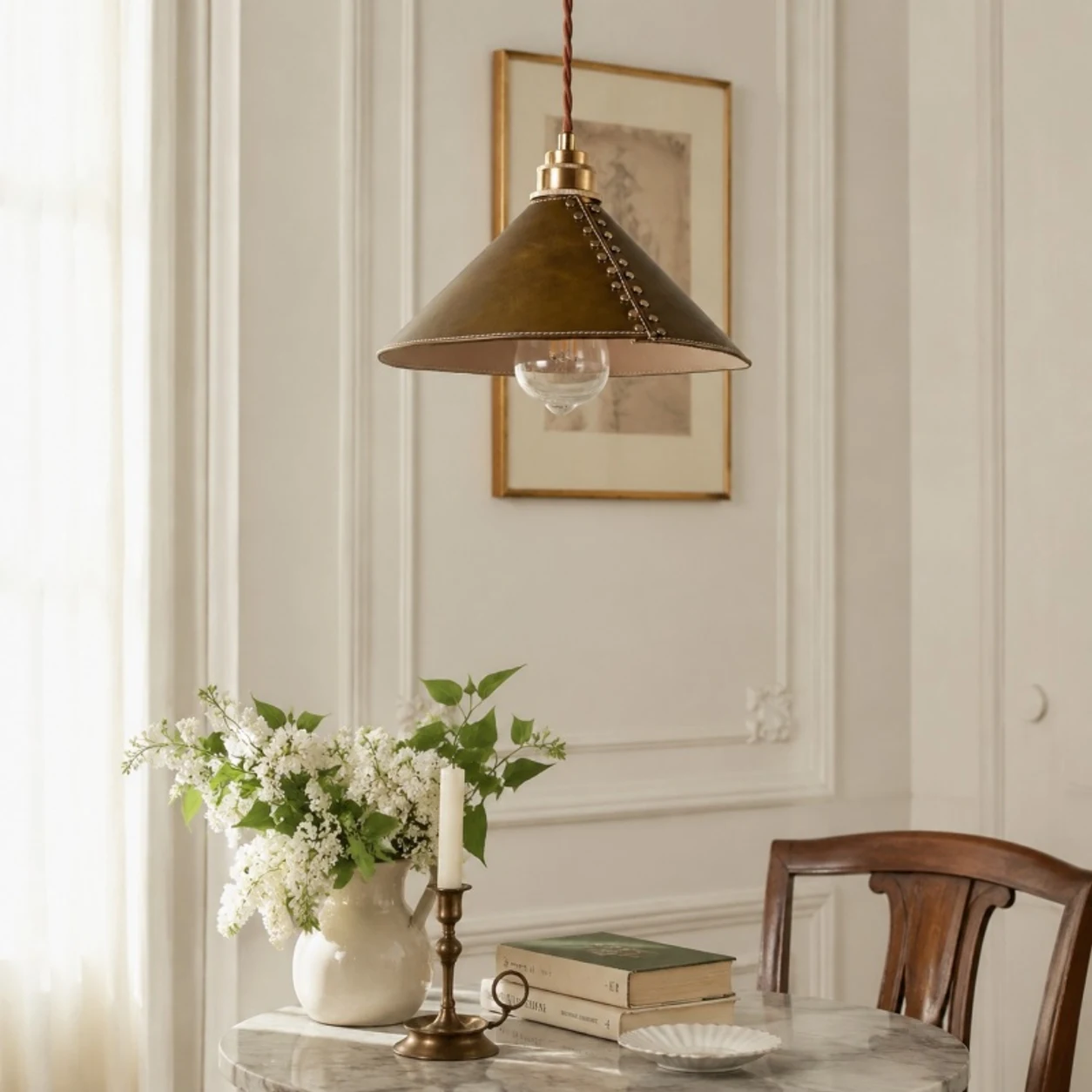 Brown leather pendant lamp above a vintage dining table