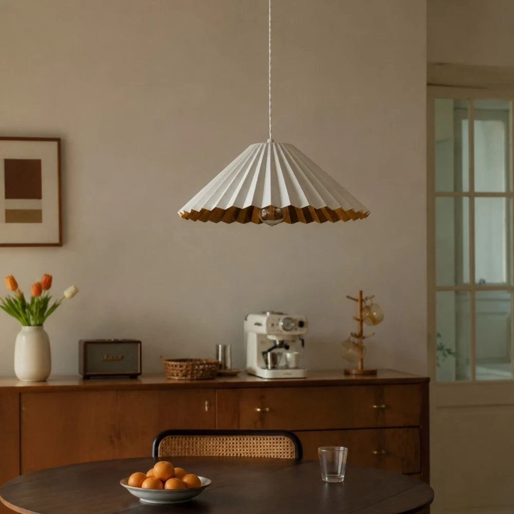 White pleated pendant lamp above a small dining table