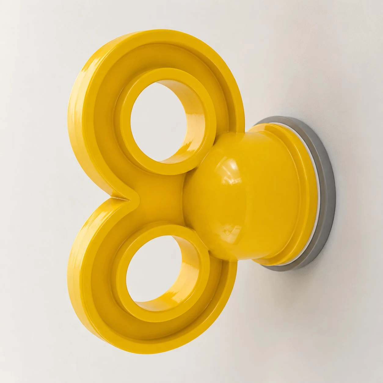 Yellow sculptural acrylic resin wall light with key shaped silhouette