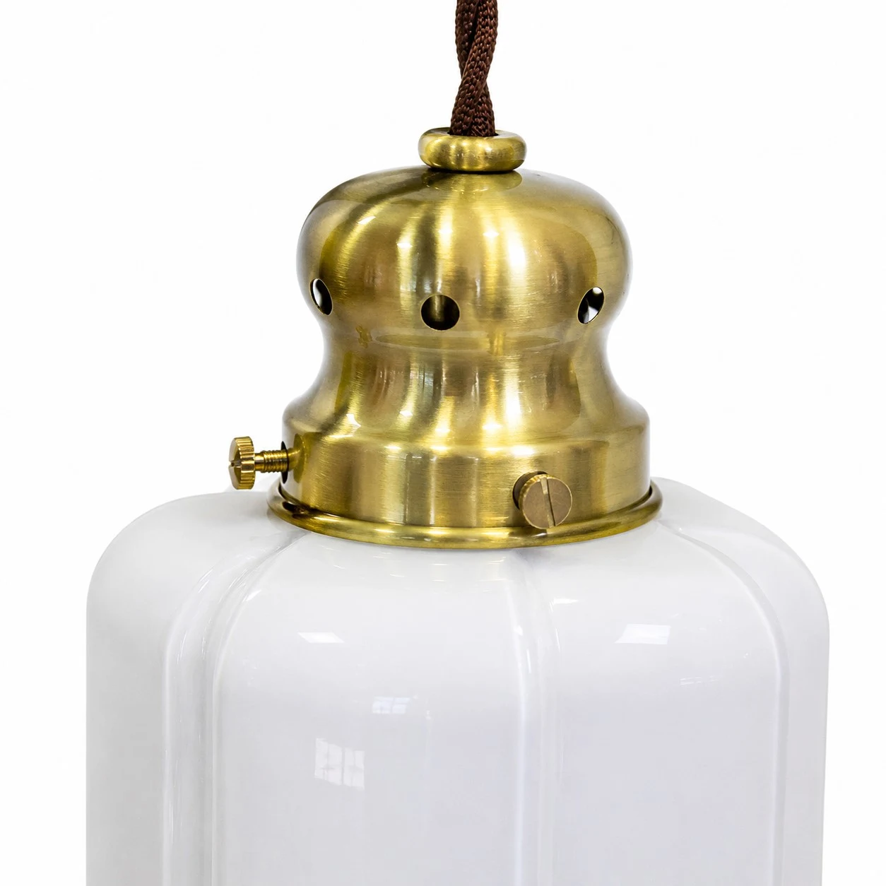 Close view of brass lamp holder and white glass shade