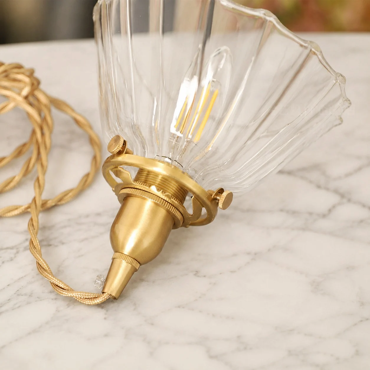 Brass-tone hardware and ribbed glass detail