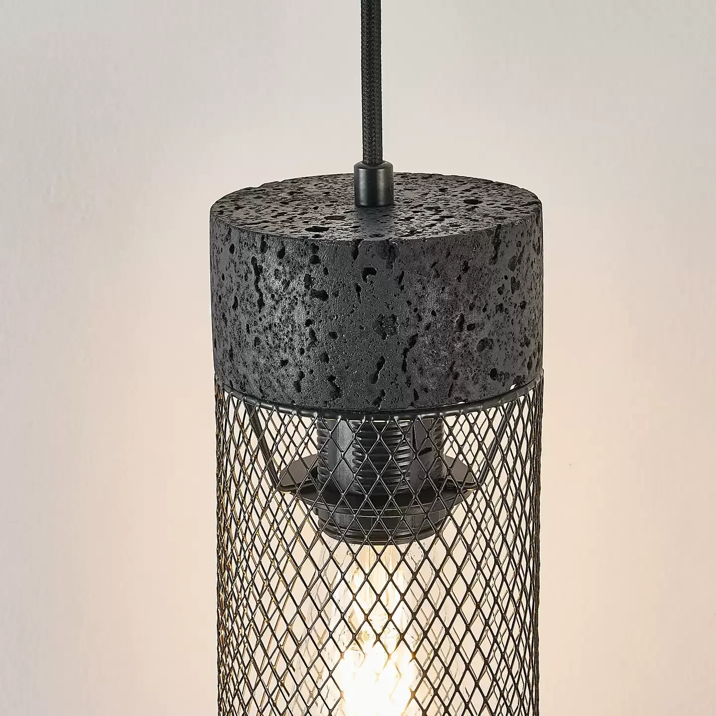 Close view of black stone top, mesh shade, and warm light