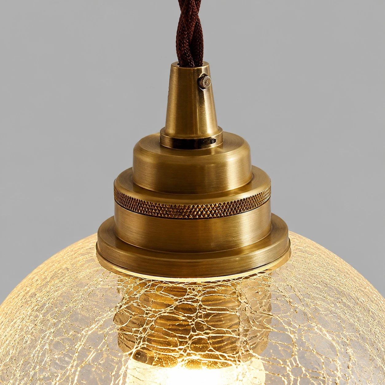 brass socket hardware and clear glass pendant shade detail
