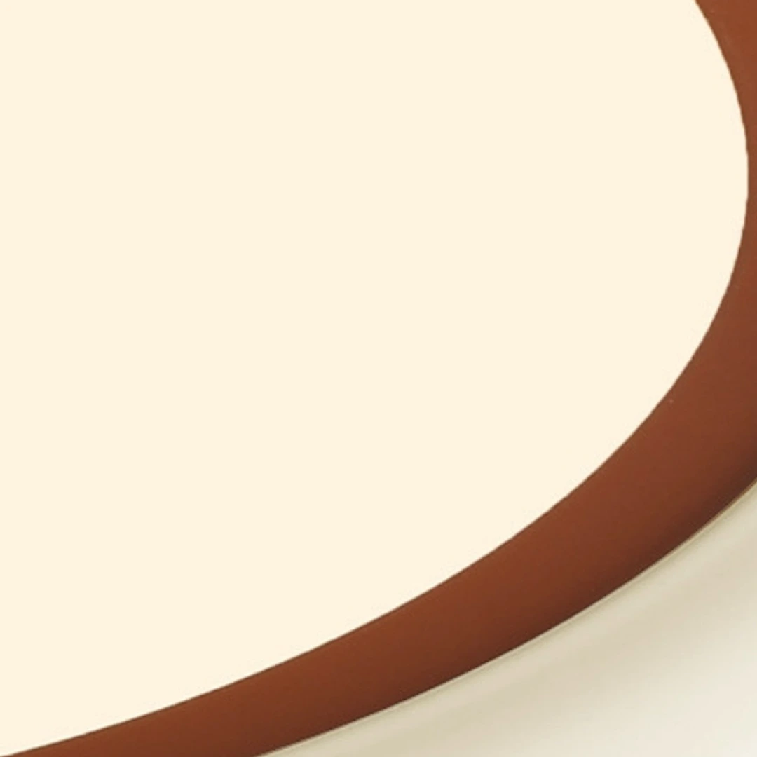 Close detail of the orange red metal rim and milky acrylic diffuser