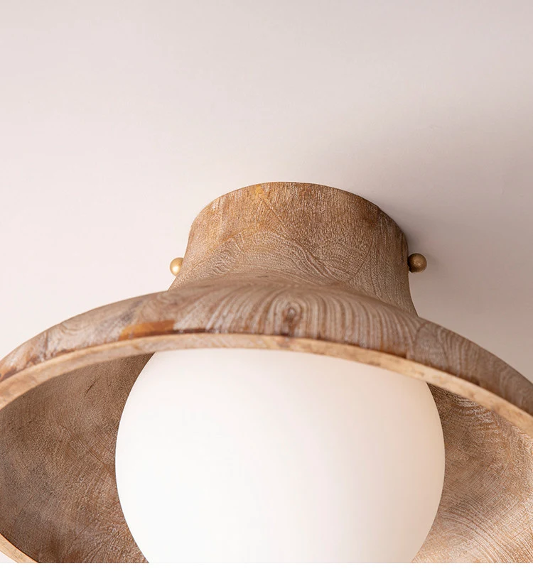 Close view of the carved wood rim and opal glass globe