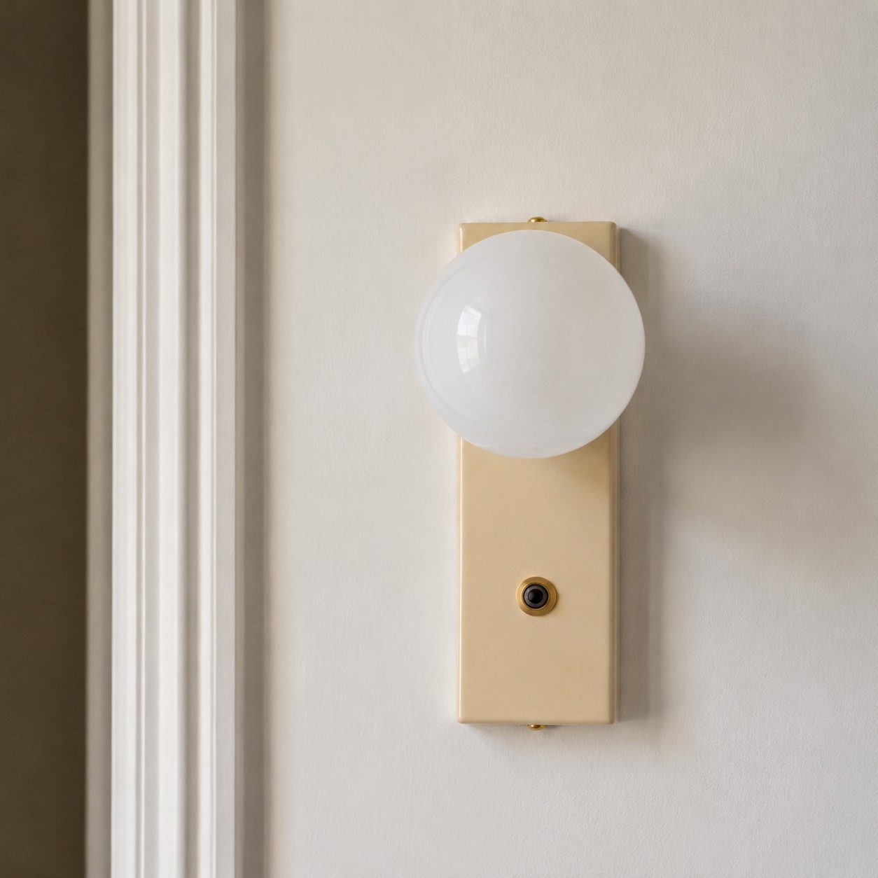 Front view of compact globe wall light on wall