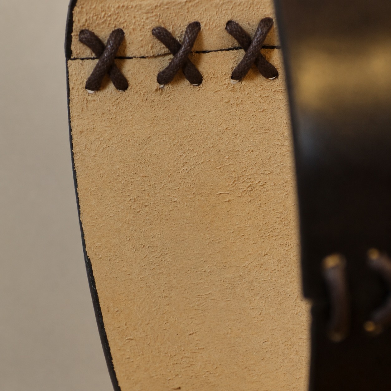 Leather pendant edge lacing close-up