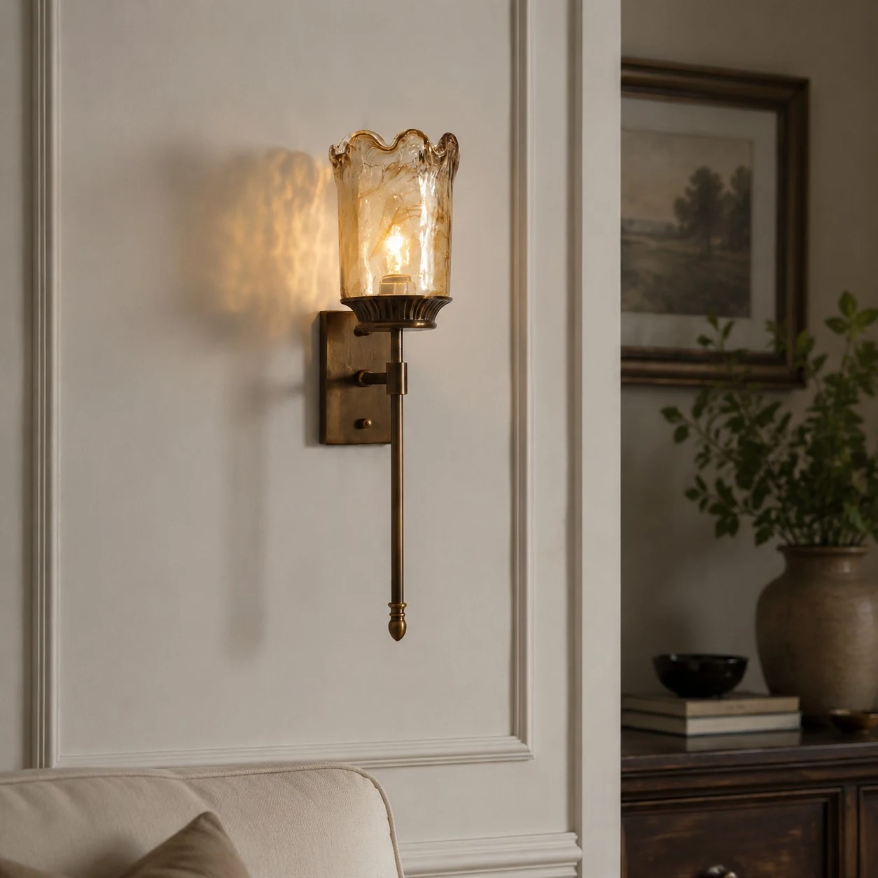 Brass amber glass wall sconce installed in a living room