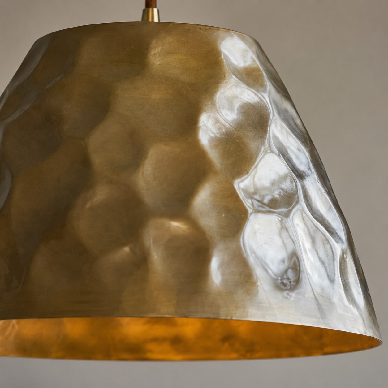 Close-up of hammered metal texture on the brass shade
