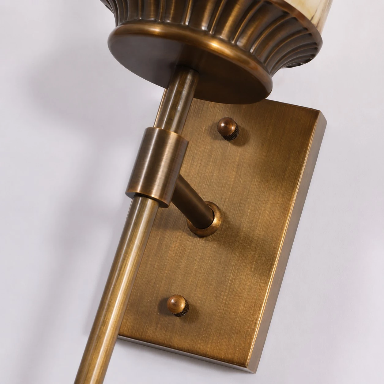 Brushed brass rectangular backplate and arm detail