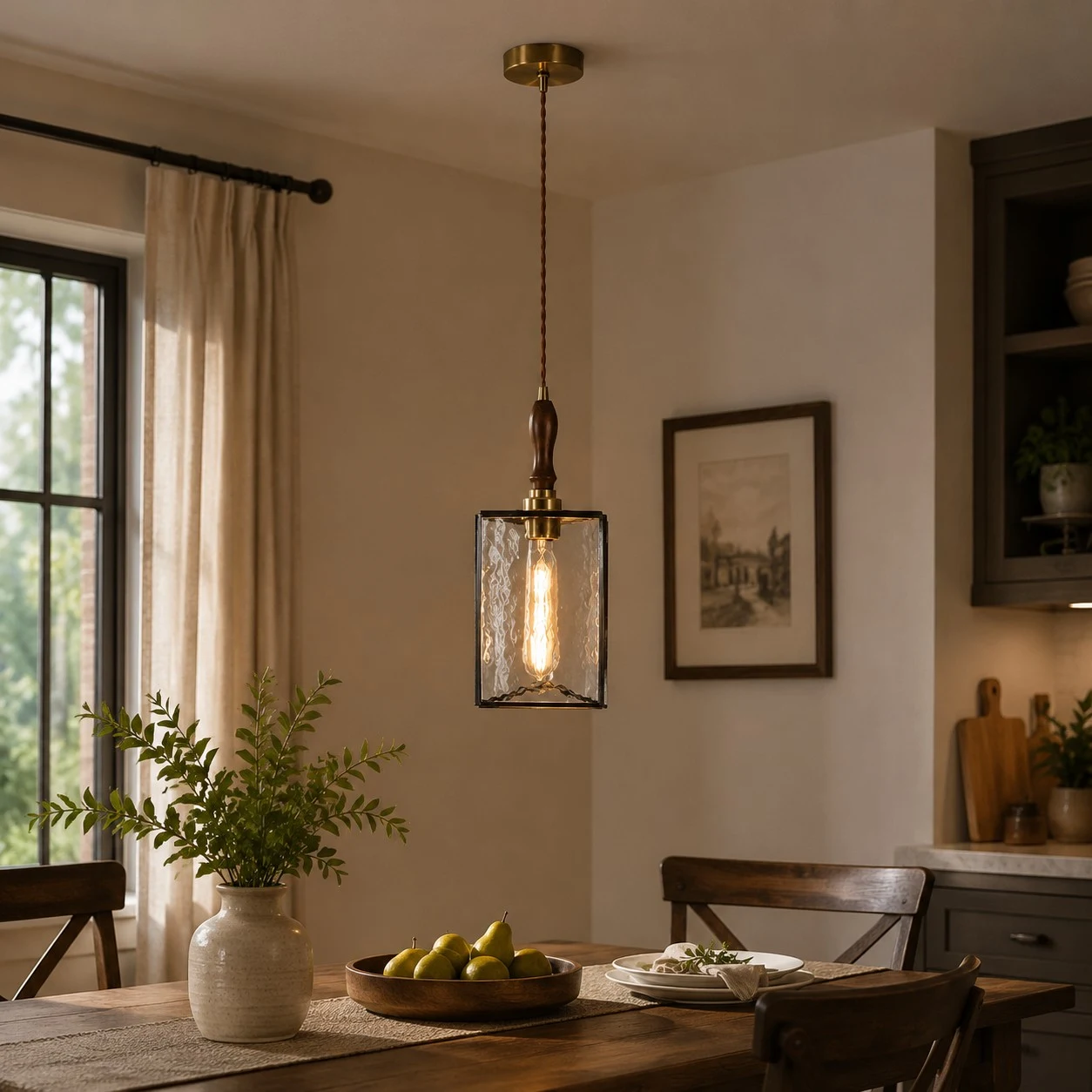 Clear glass pendant installed above a dining table