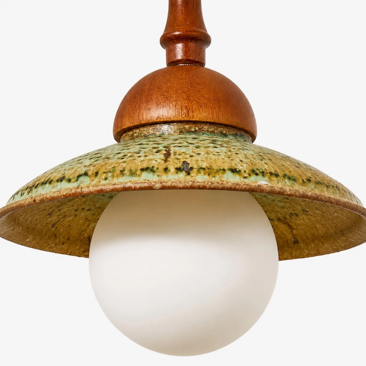 Close view of textured ceramic-look shade and frosted globe on the wabi sabi wall light