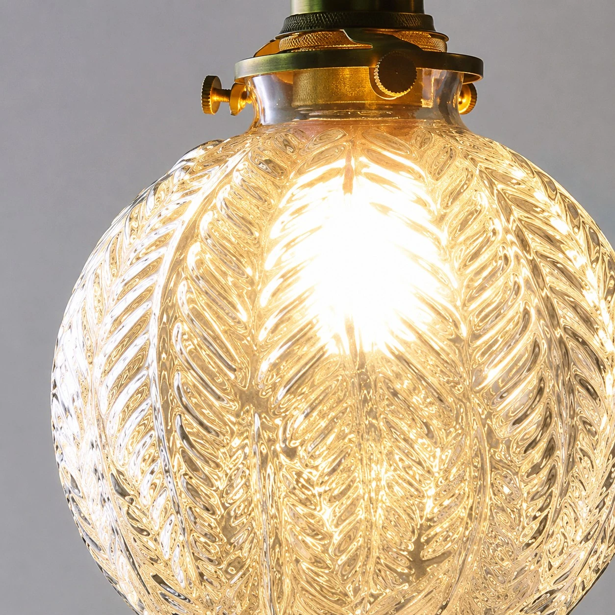 ribbed clear glass pendant shade with warm bulb glow