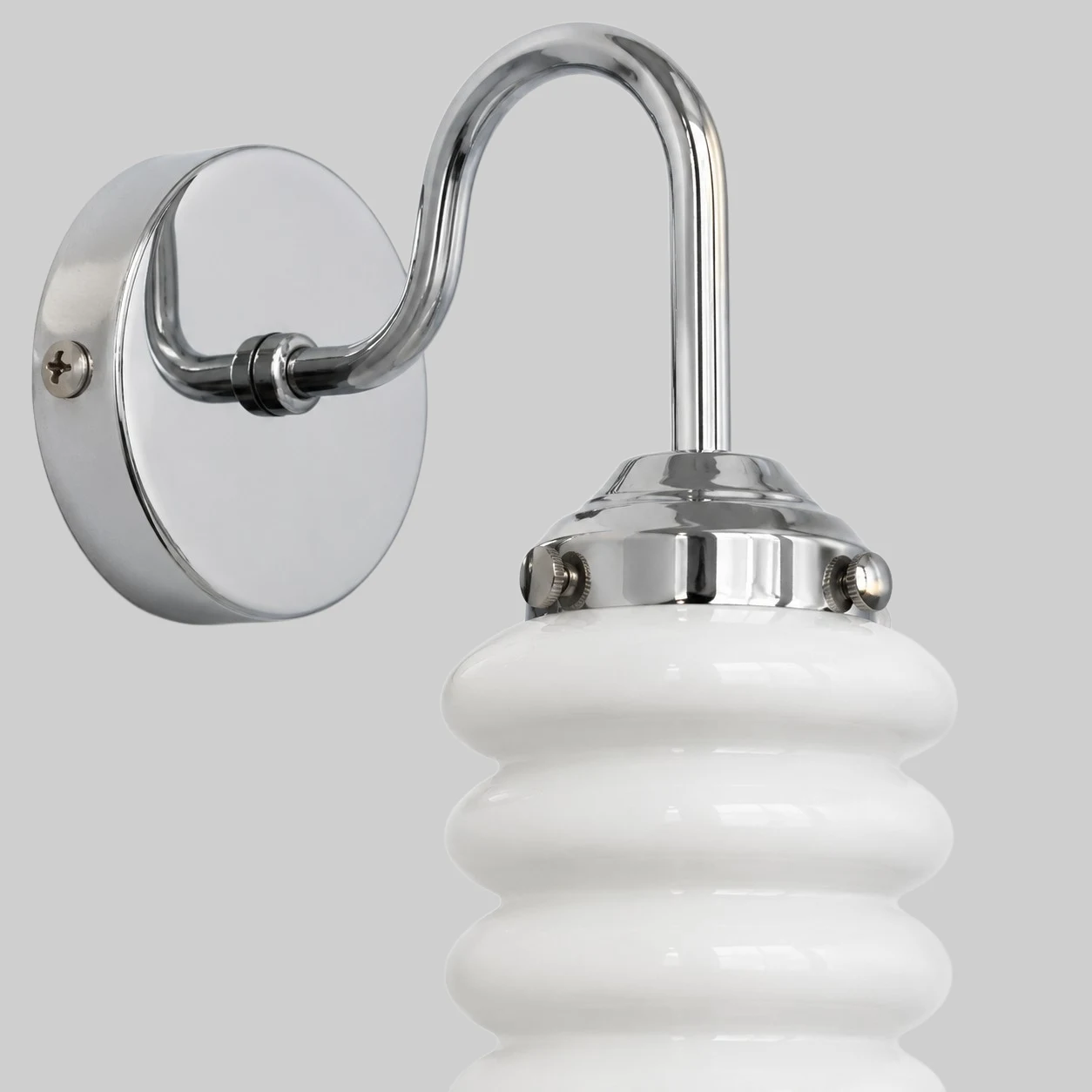 Chrome wall plate and white ribbed glass shade close view