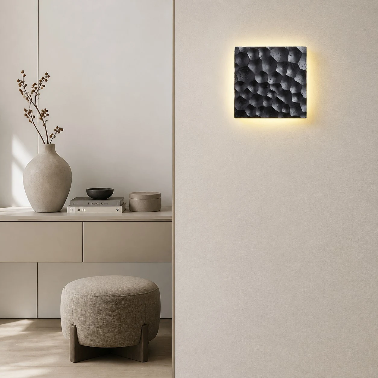 Pair of carved travertine wall sconces installed on a modern wall