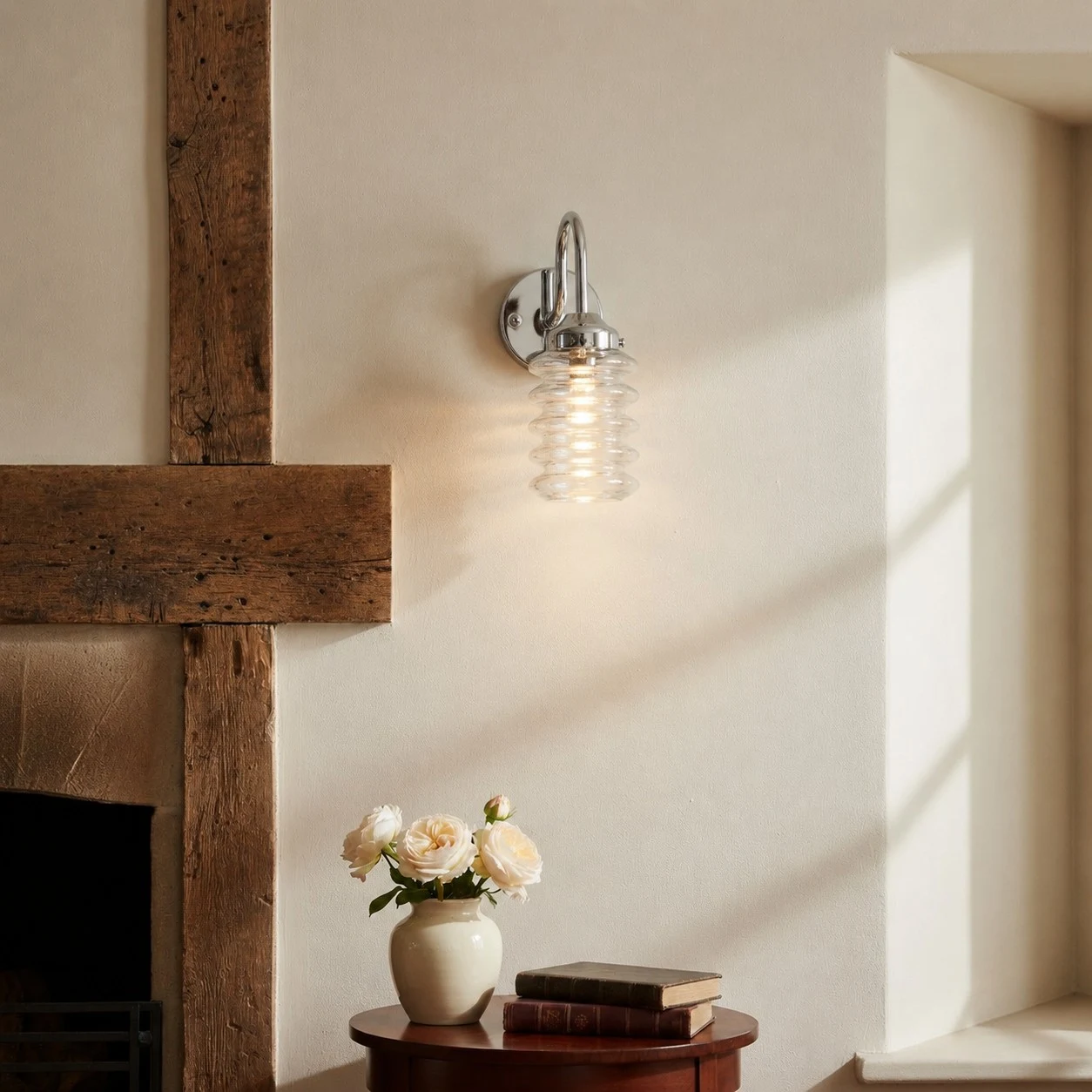 Chrome ribbed glass wall sconce adding soft light to a plaster wall