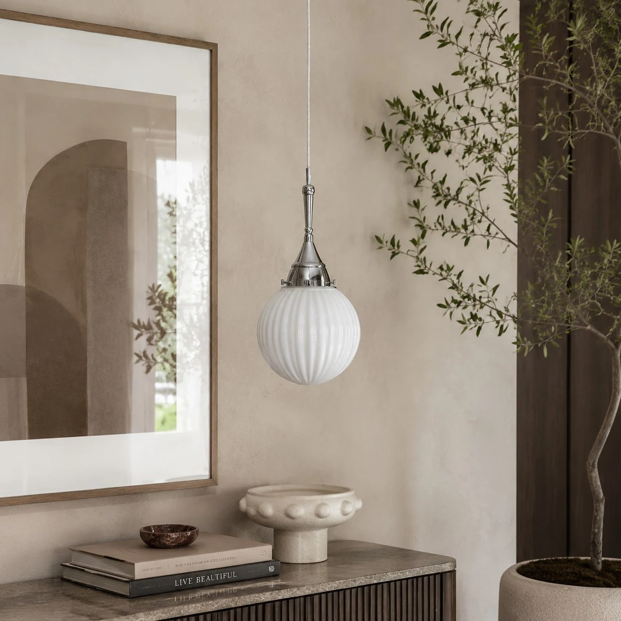 Ribbed glass pendant in a warm neutral room