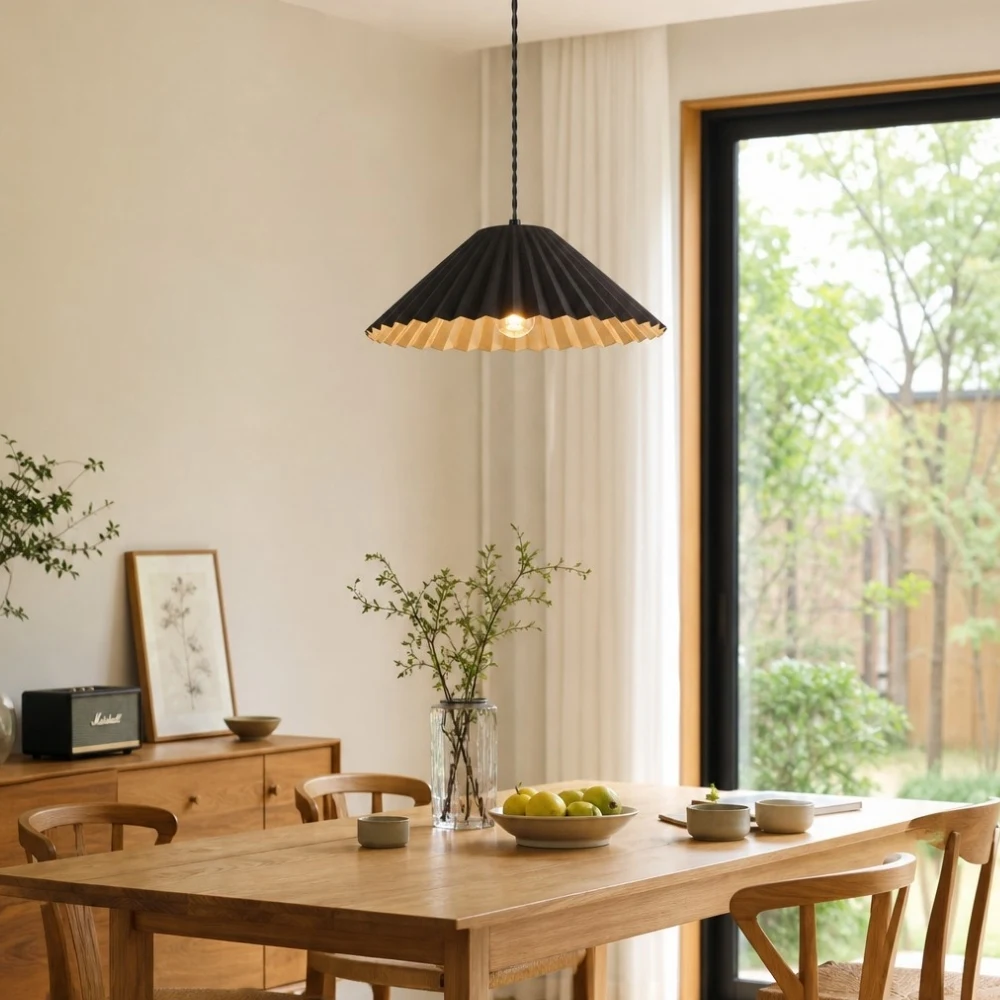 Black metal dome pendant lamp over a dining table