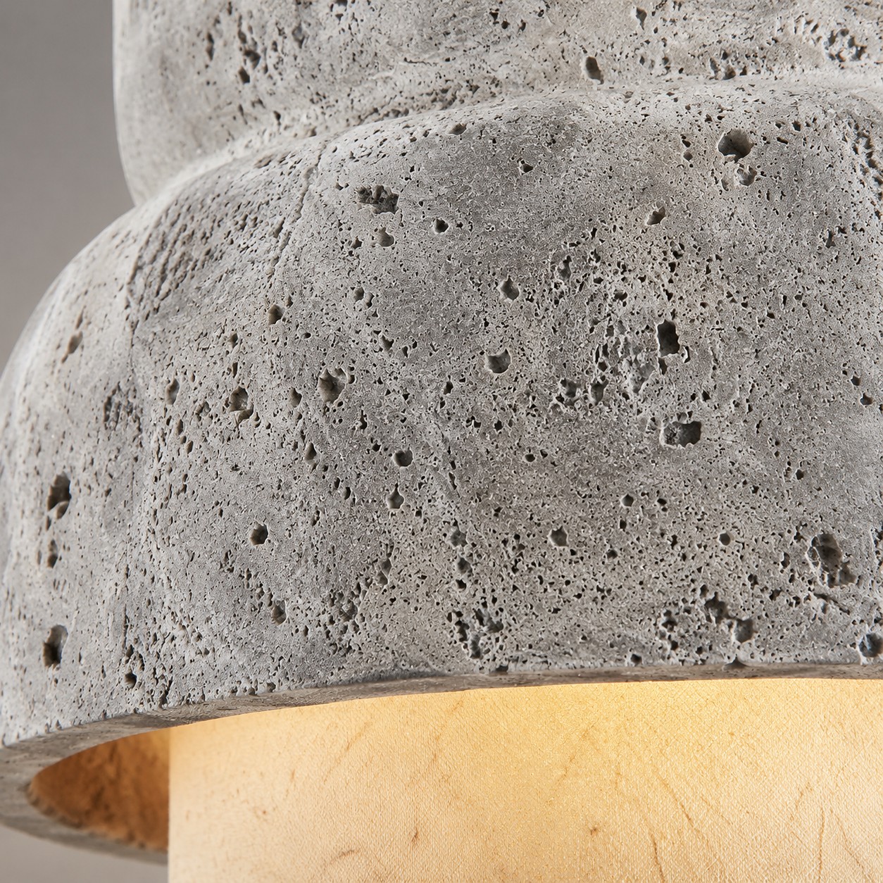 Macro close-up of porous gray travertine stone texture