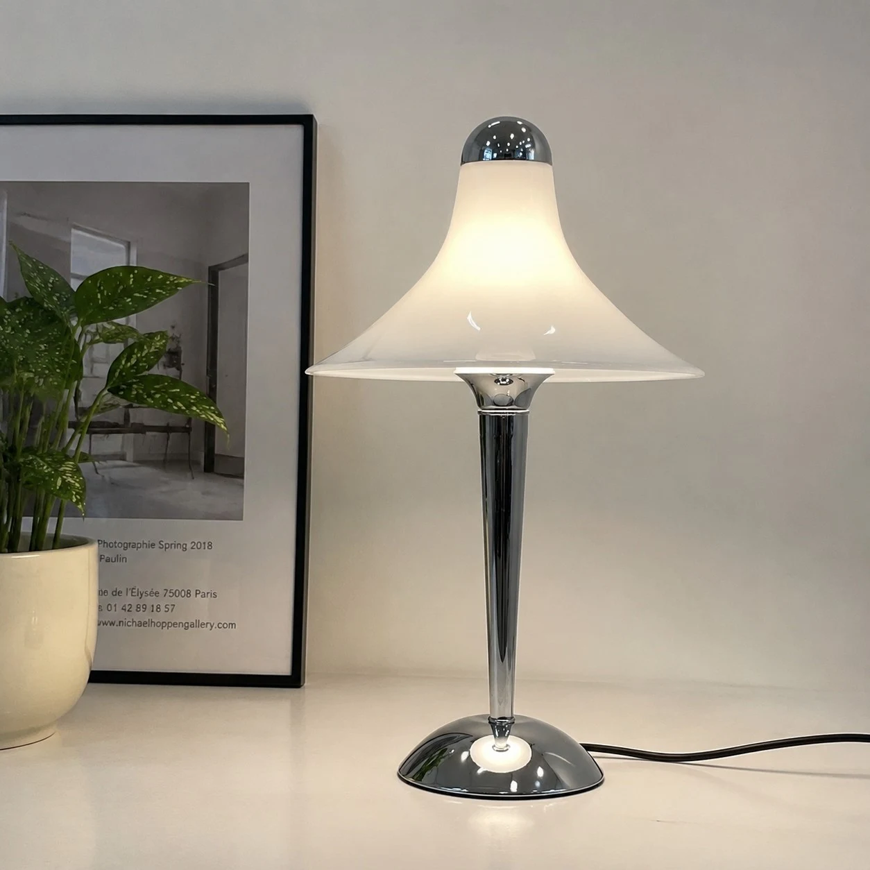 White table lamp near framed wall art