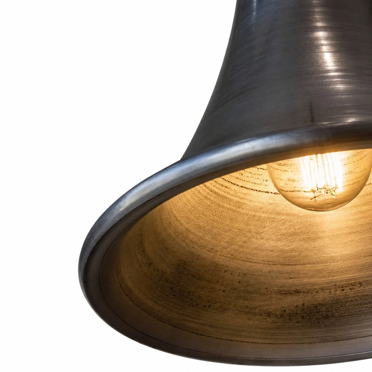 Warm light inside the brushed metal shade