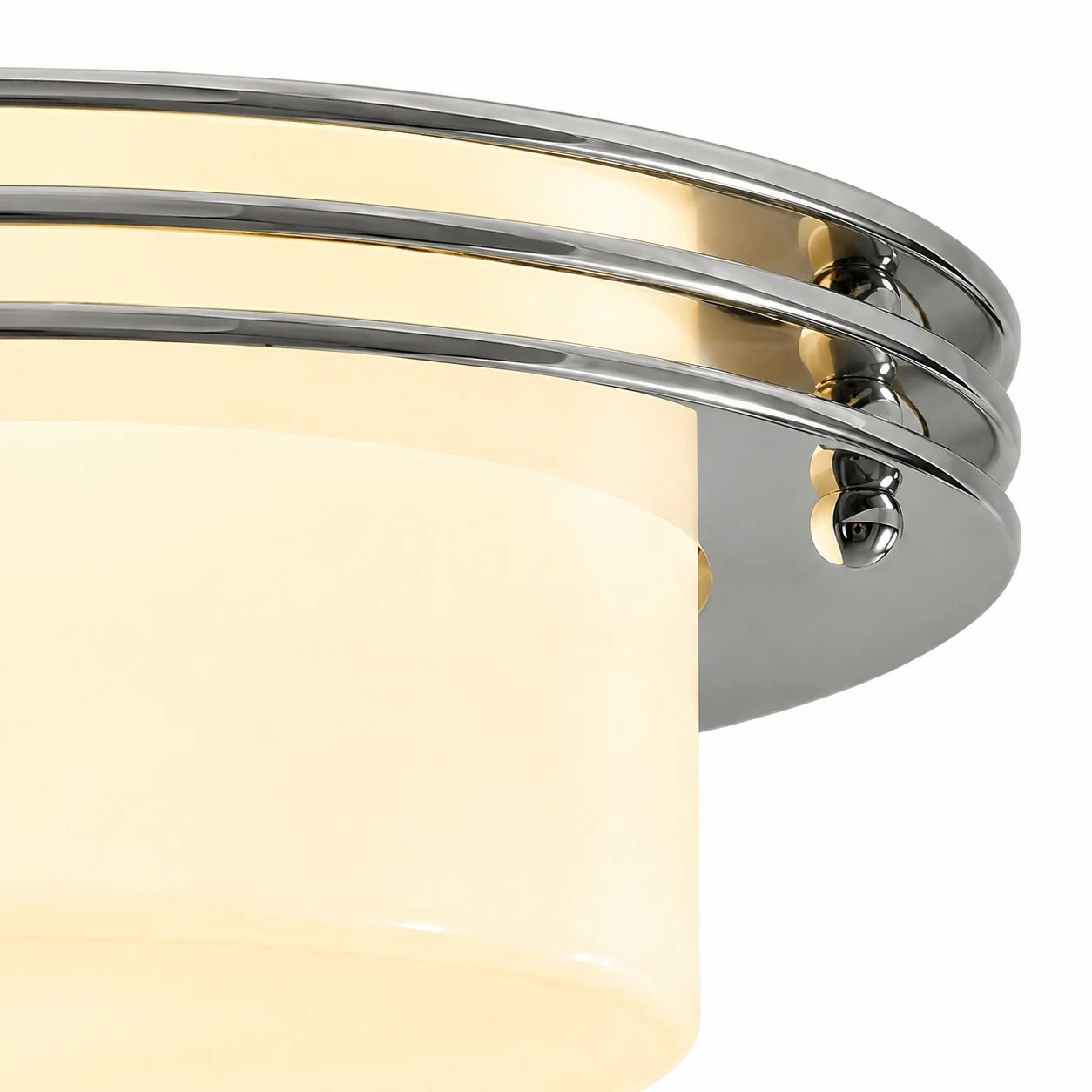 Low profile Bauhaus disc silhouette with chrome bands and milky white shade